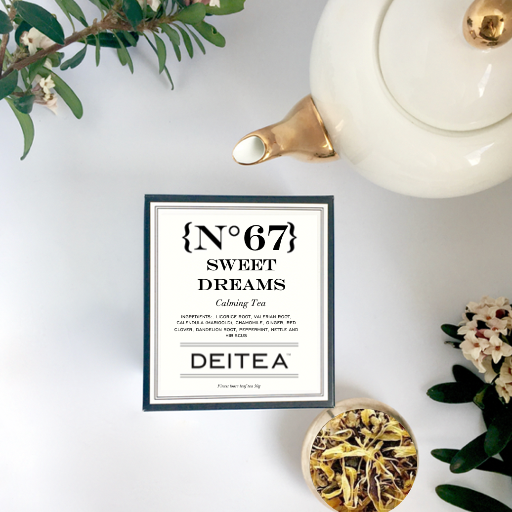 elegant black and white tea box with gold and white teapot and fresh daphne flowers
