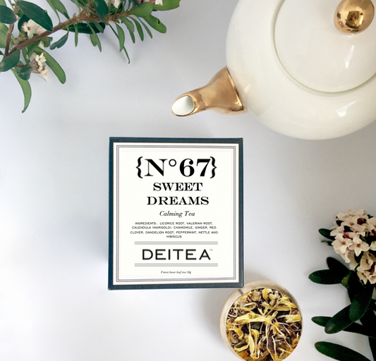 elegant black and white tea box with gold and white teapot and fresh daphne flowers