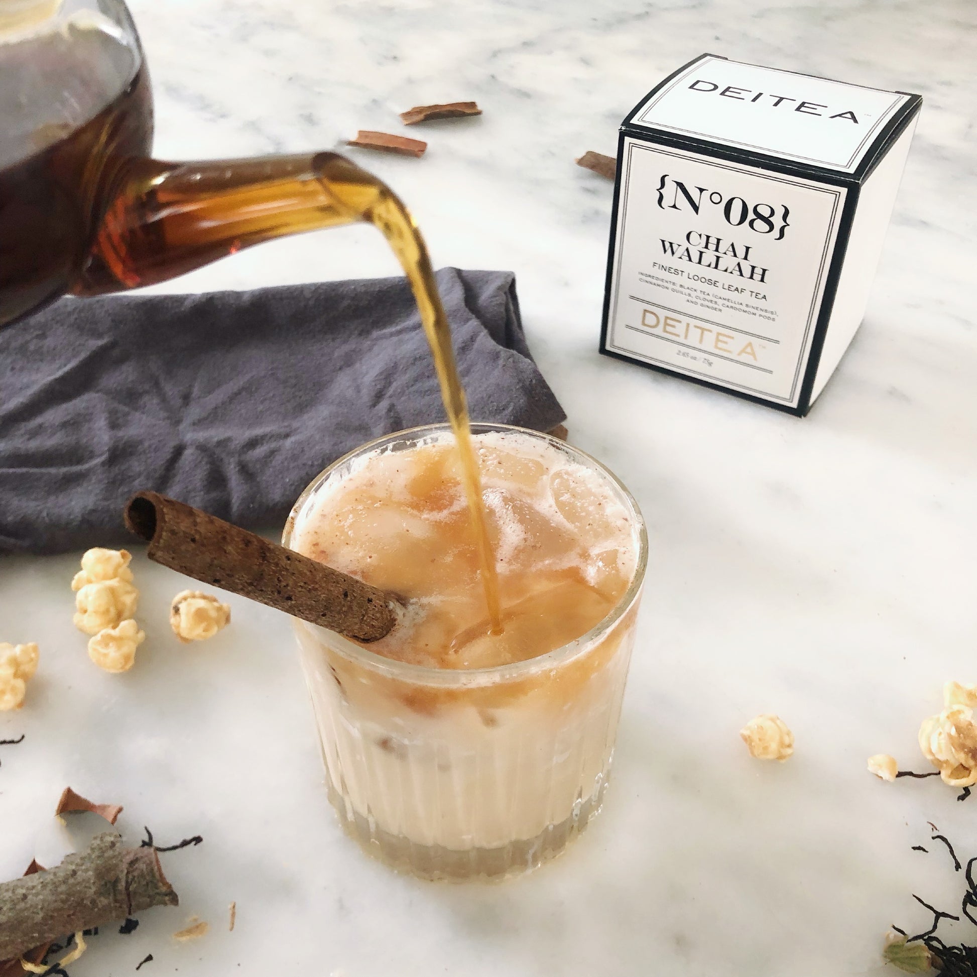 Deitea's No.08 Chai Wallah Loose Leaf Tea poured over ice and coconut milk – a refreshing spiced tea blend with cinnamon, cardamom, cloves, and ginger.